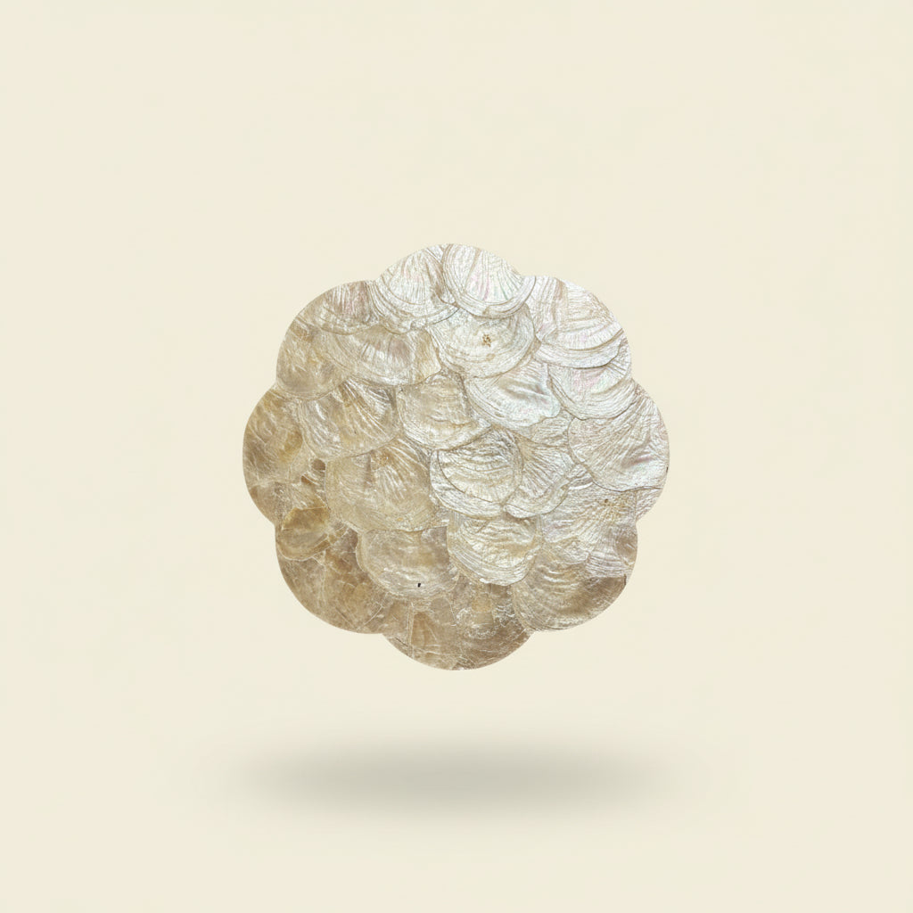 Handcrafted placemat featuring layered mother-of-pearl shell with soft natural iridescence by Lumora Luxe