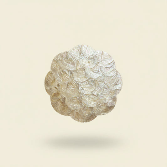 Handcrafted placemat featuring layered mother-of-pearl shell with soft natural iridescence by Lumora Luxe